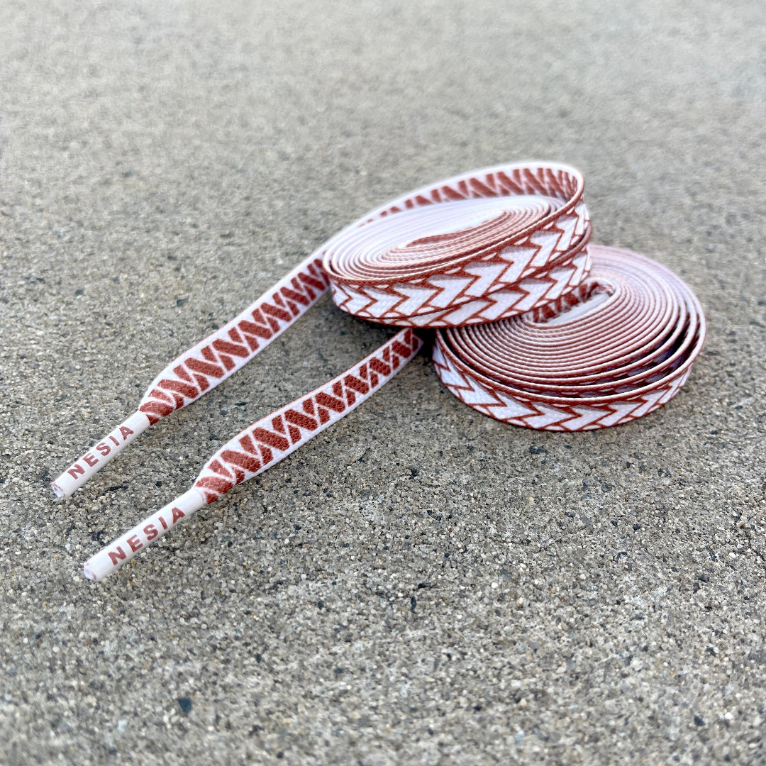 Nesia Originals Polynesian design shoeslaces rolled up on cement