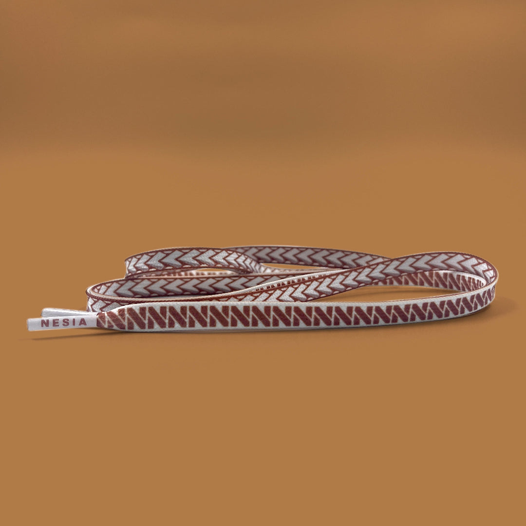 Nesia Originals Polynesian design shoelaces on brown background